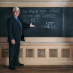 Texas Engineer Bob Metcalfe standing in front of chalk board