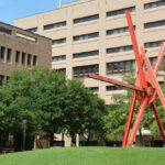 Clock knot sculpture in front of engineering teaching center and chemical and petroleum engineering building