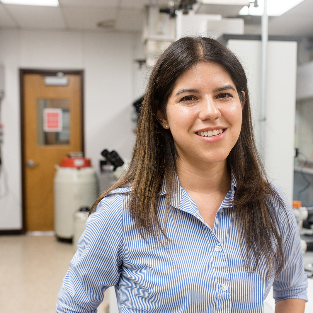 Portrait of Adrianne Rosales smiling in her lab