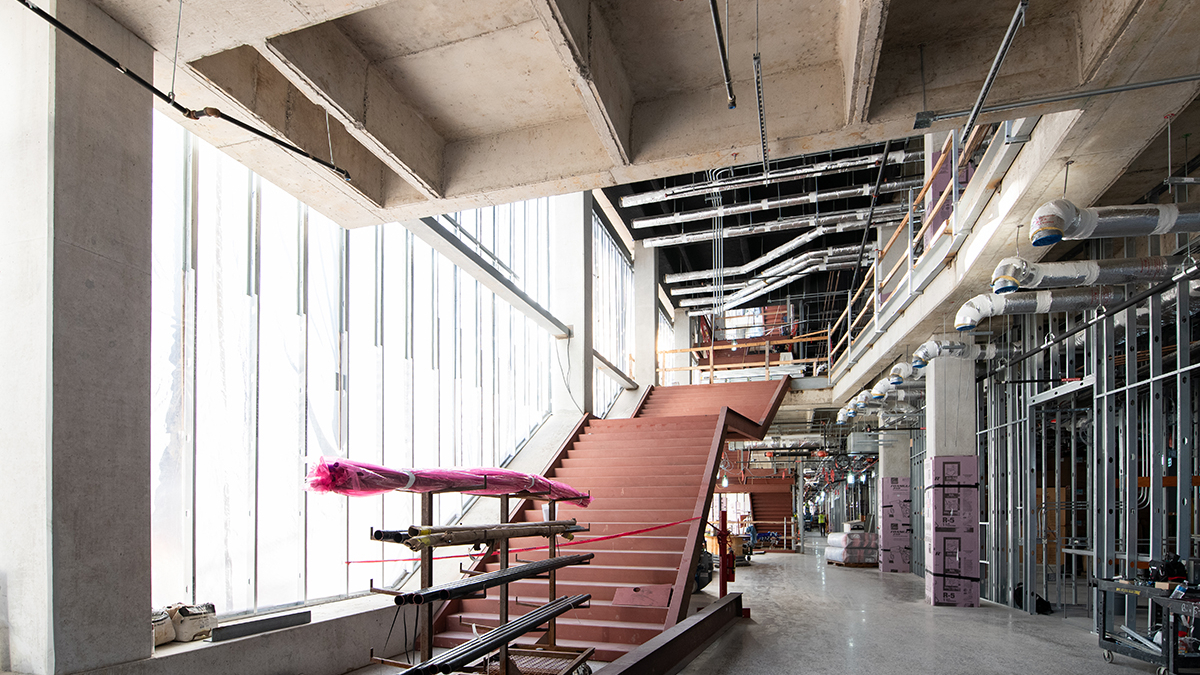 The ground floor entrance of the Gary L. Thomas Energy Engineering Building, highlighting the floor to ceiling window and grand staircase