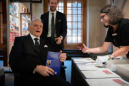 John Goodenough gives a copy of his book to the nobel museum