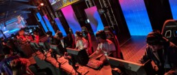 Longhorn Gaming team playing video games on computers on stage