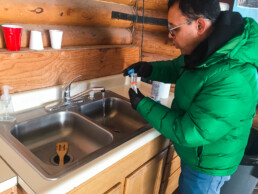 professor Navid Saleh testing samples at a sink