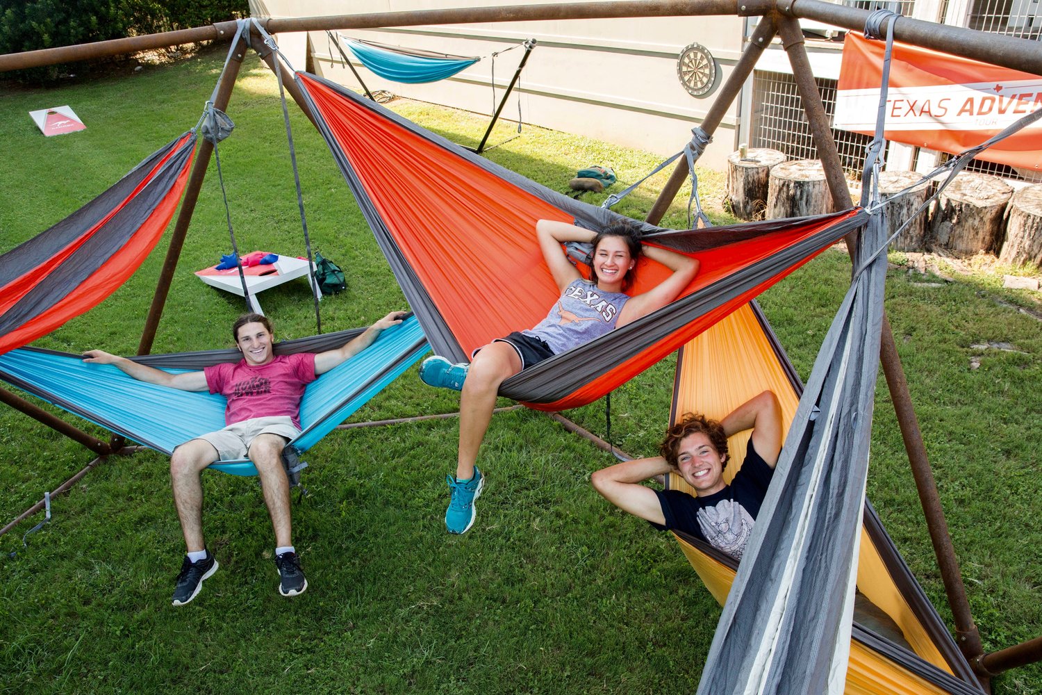 Members of the Nido Structures Team Zane Lewin, Olivia Nguyen and Daniel Goodwin lounge in hammocks of their free-standing structure
