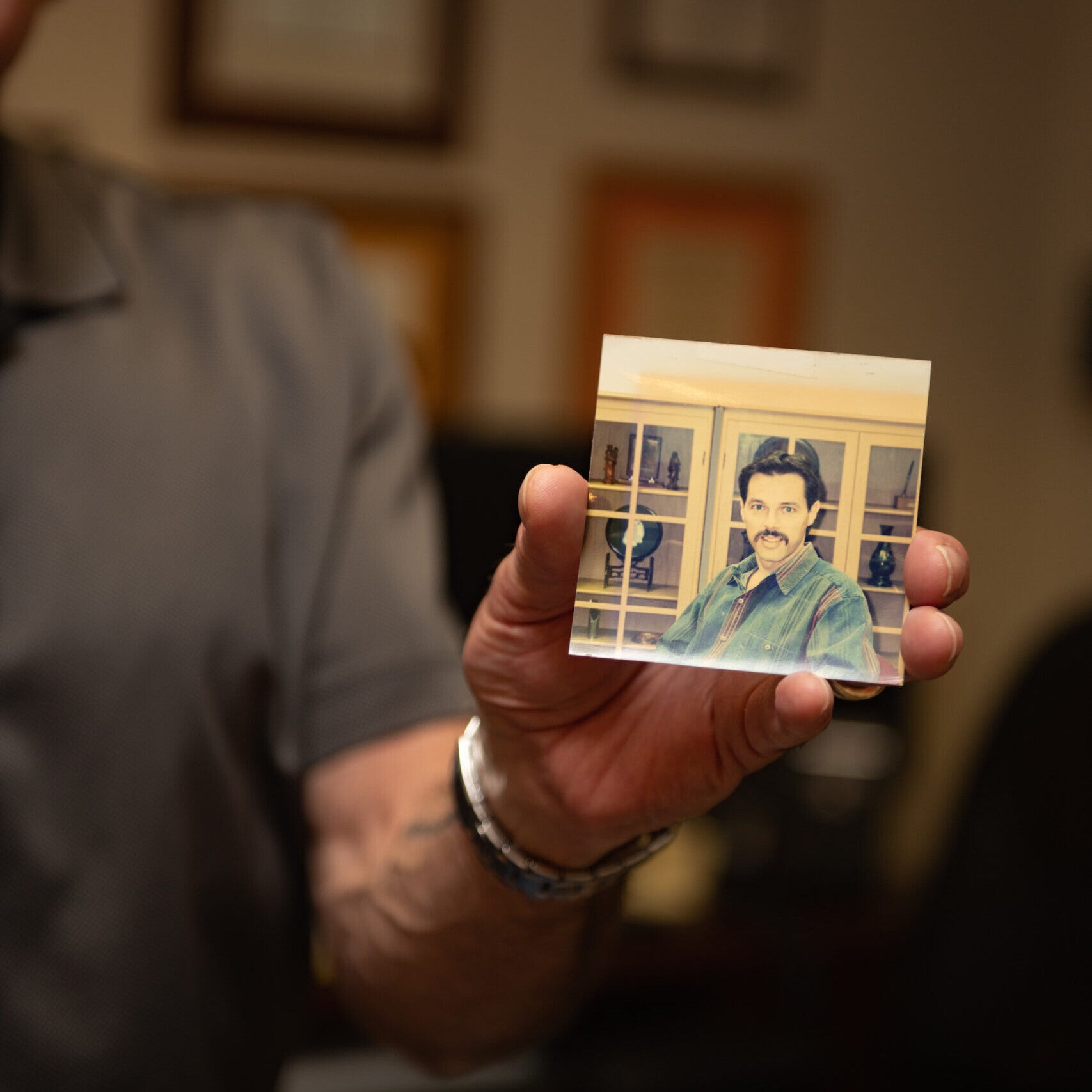 Glen Baum holding an old photo of Glen Baum