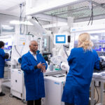 Texas Engineer Arumagam Manthiram talking to researchers in his battery research lab