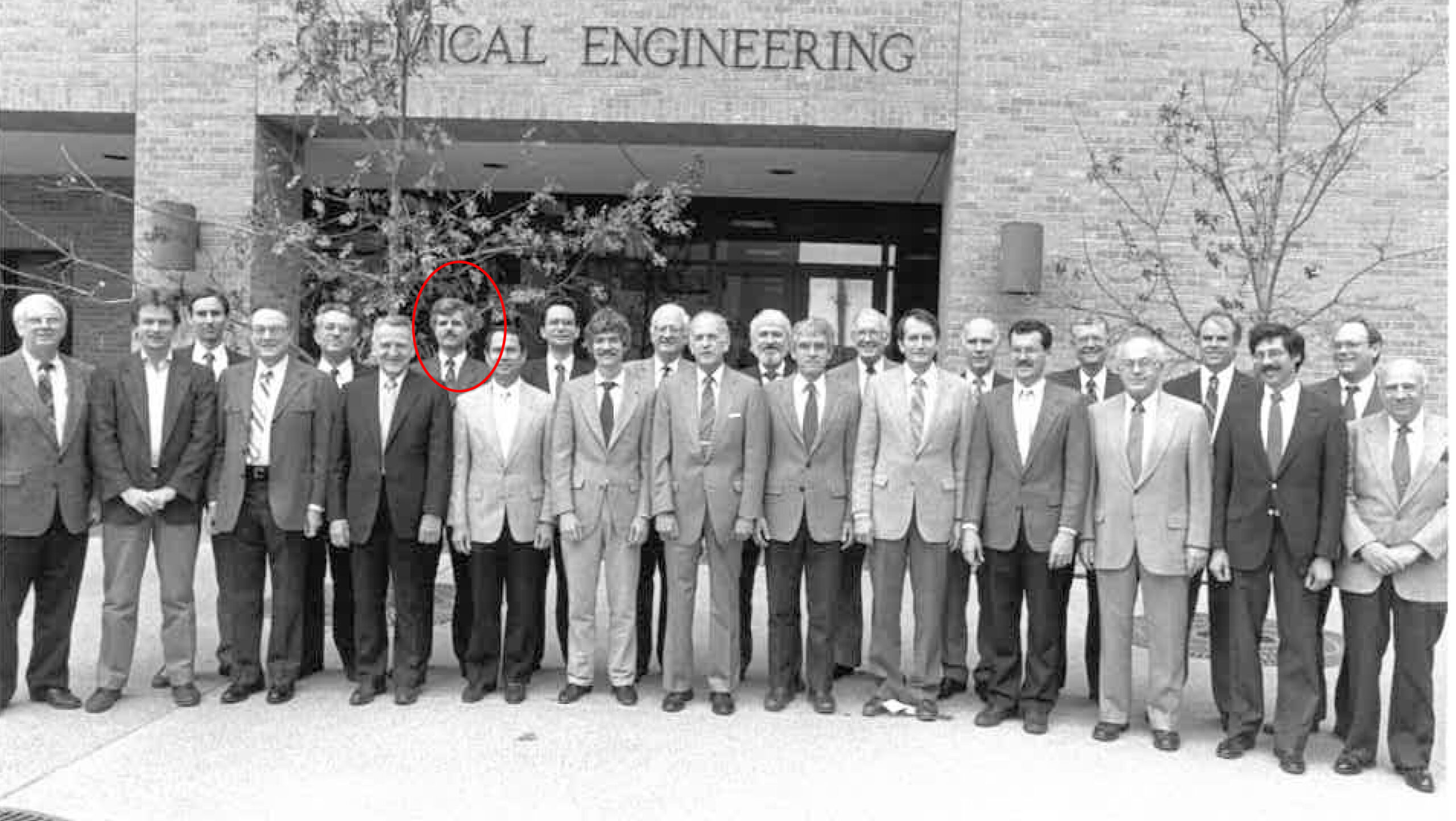 black and white photo of John Ekerdt and group of men outside UT Austin mechanical engineering building