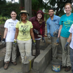 Texas engineering students smiling in concrete structure