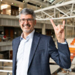 Texas Engineering Dean Roger Bonnecaze doing hook 'em horns hand sign