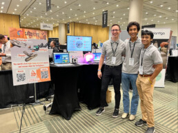 Paradigm Robotics team standing in front of table and presentation posters