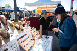 Vargas helps customer at farmers market