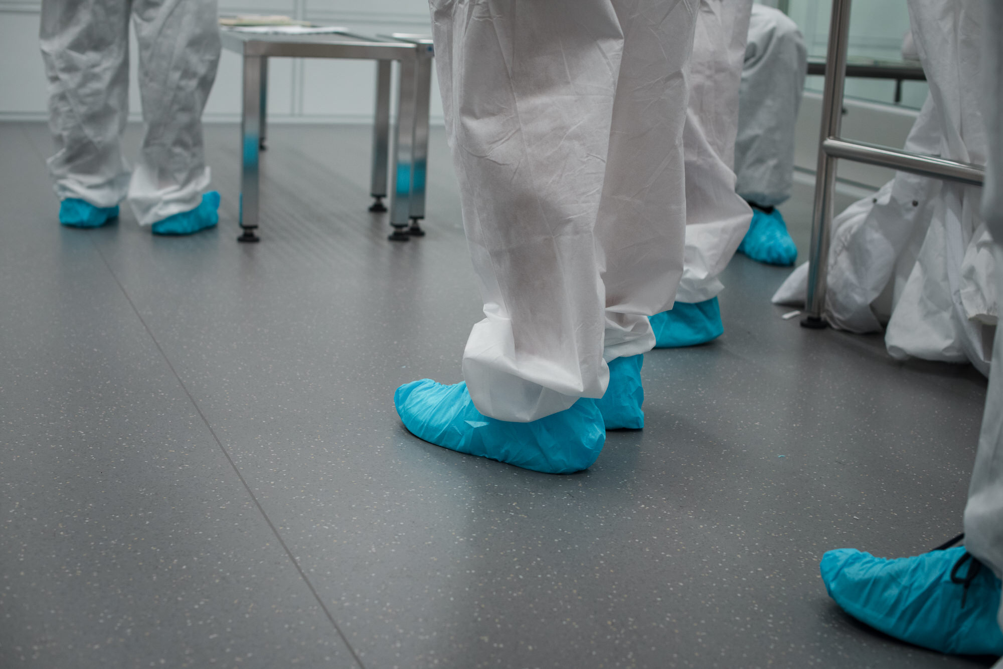 Close up of Texas Engineers' gloved shoes in a semiconductor lab