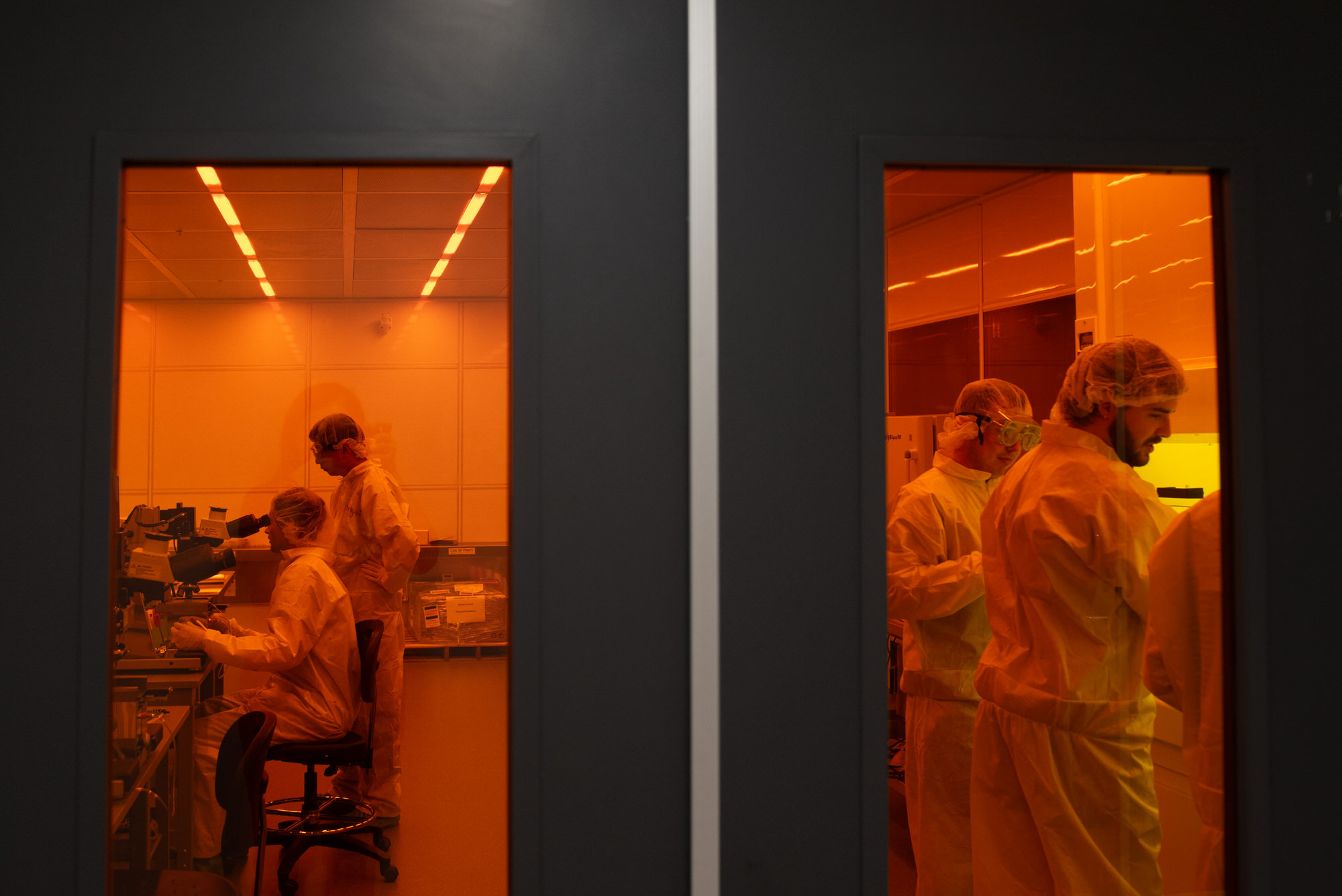 Glass doors showing Texas Engineers working in chips lab