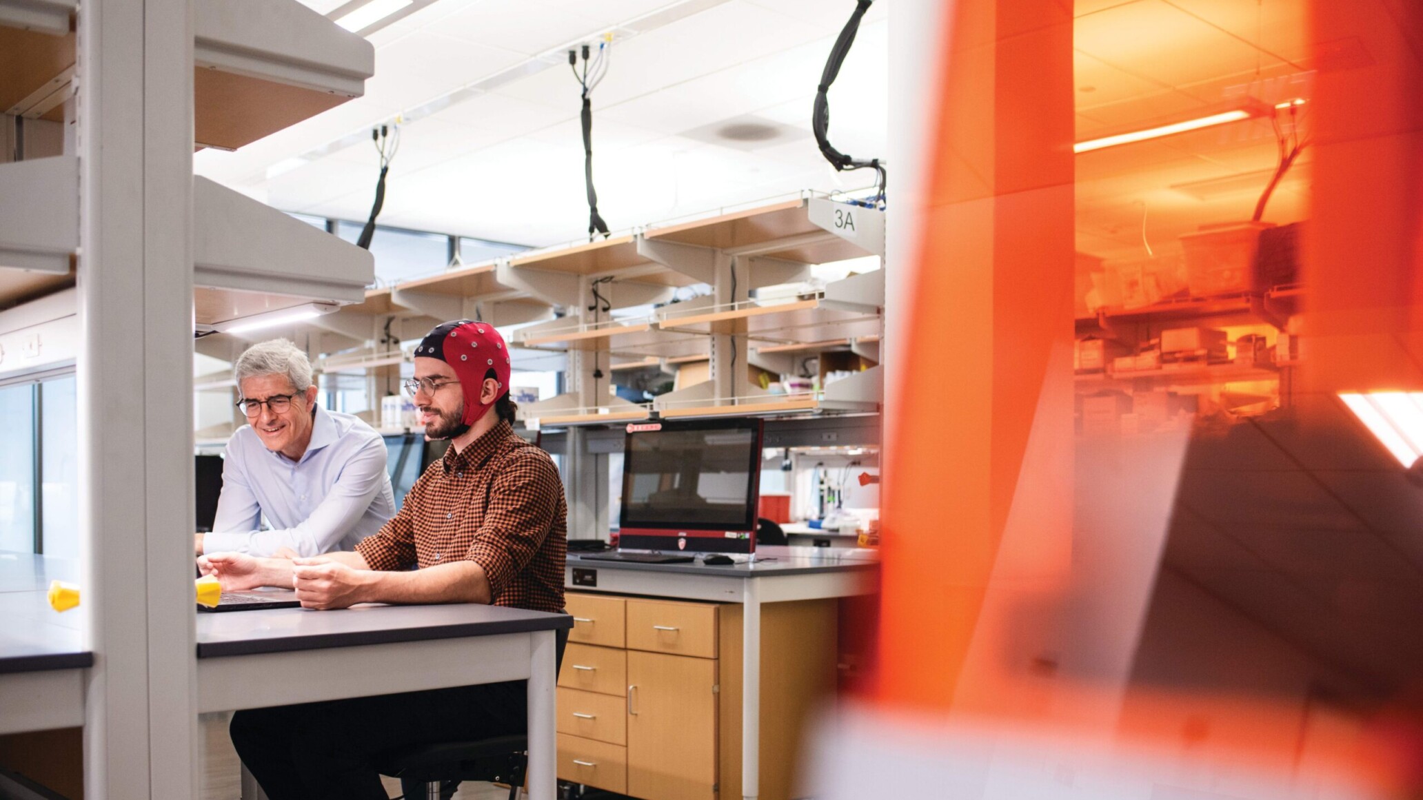 Texas Engineer Jose Millan and graduate student working on machine learning research in lab