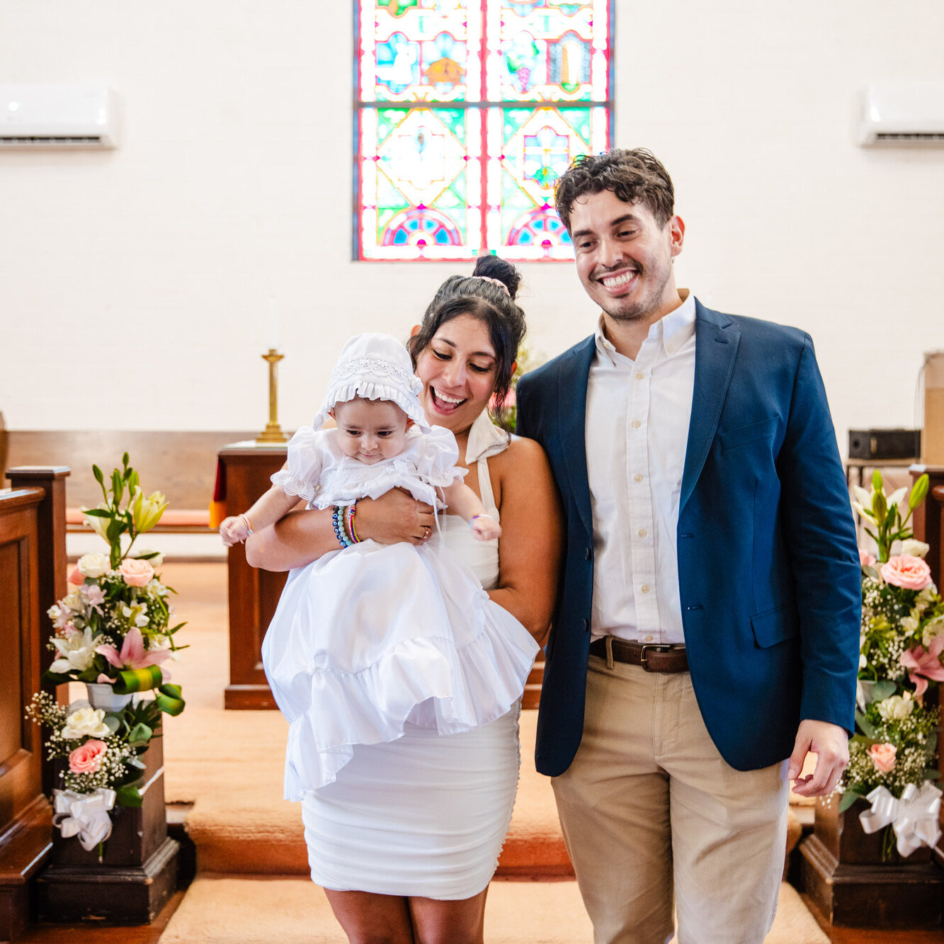 Texas Engineers Anali and Julian Gonzalez smiling at their baby's christening