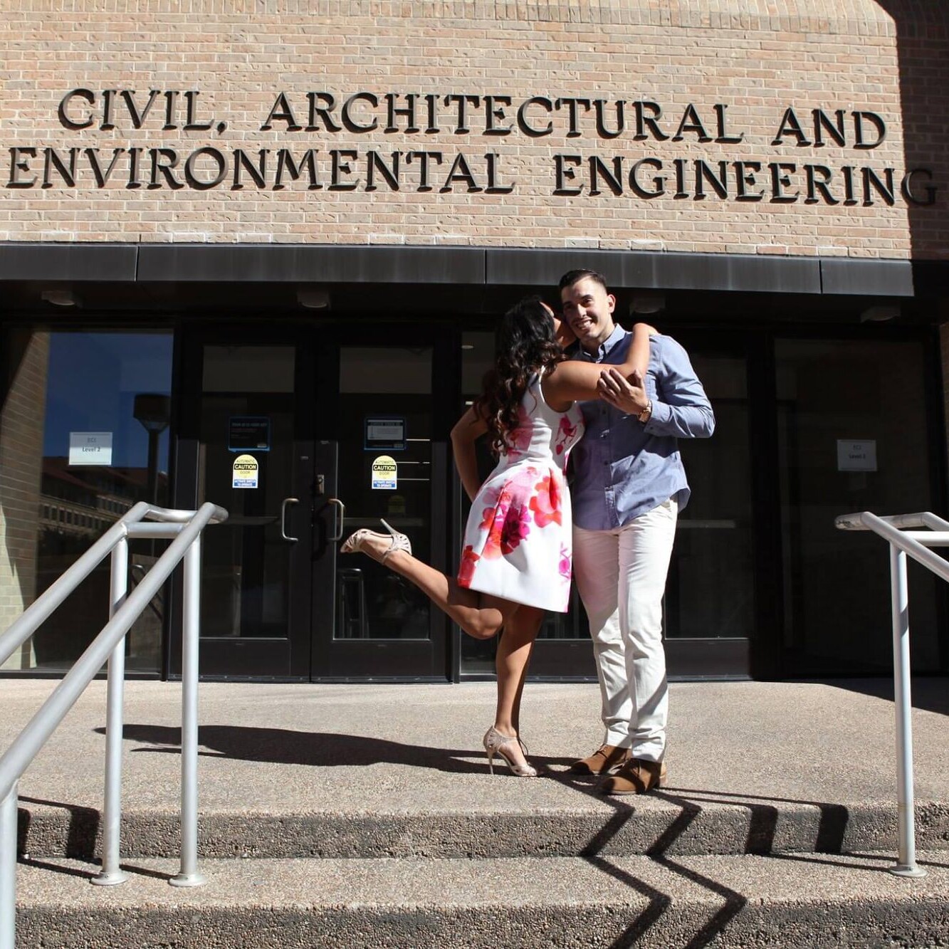 Texas Engineers Anali and Julian Gonzalez smiling in front of CAEE building on UT Austin campus