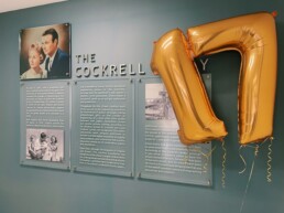 A seventeen balloon floating next to the Cockrell story display on the wall