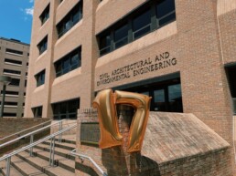 A seventeen balloon floating in front of the Civil, Architectural and Environmental Engineering building