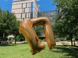 A seventeen balloon floating in front of the EERC building