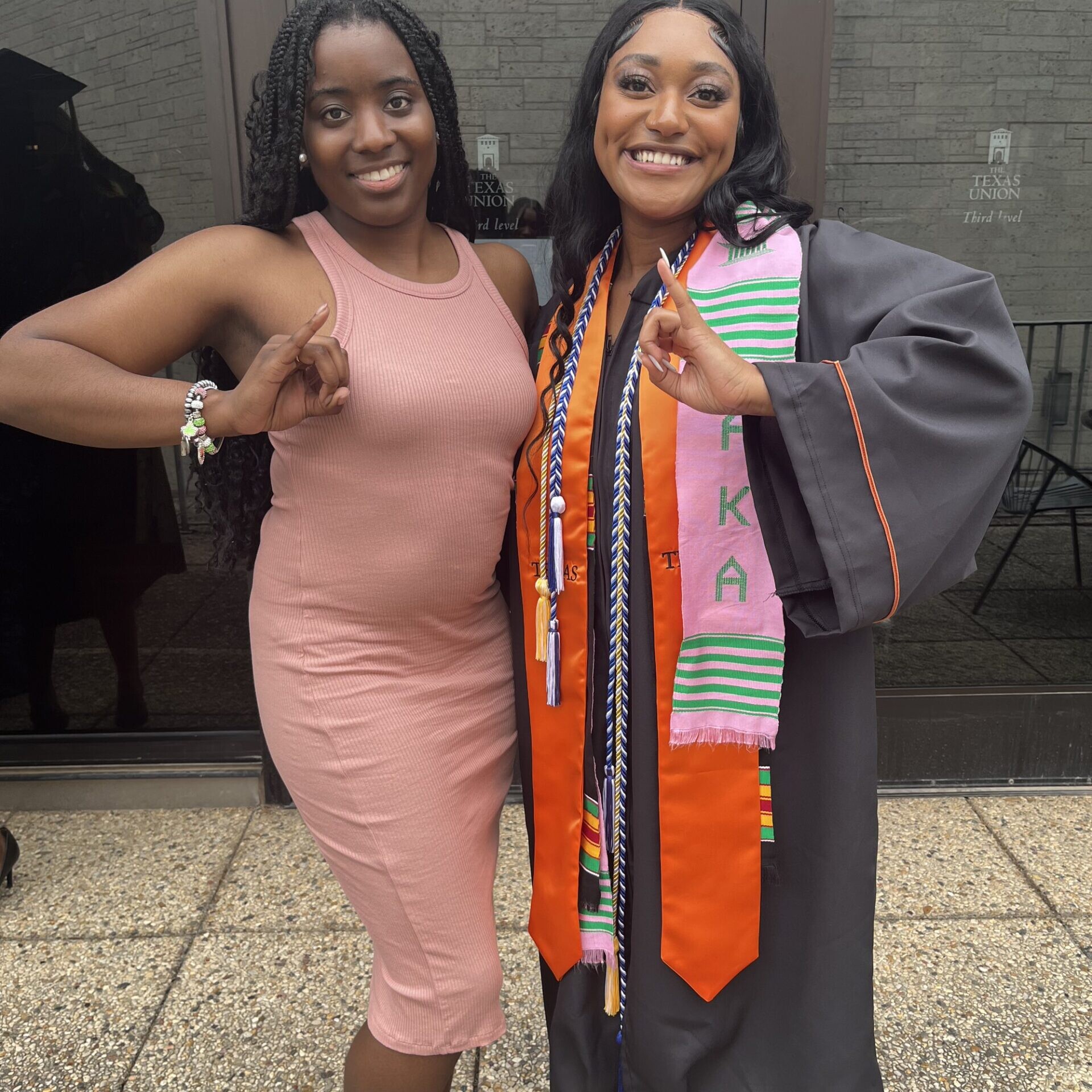 NSBE Texas Engineering students smiling in graduation regalia