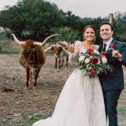 Shannon and Scott with longhorns at wedding