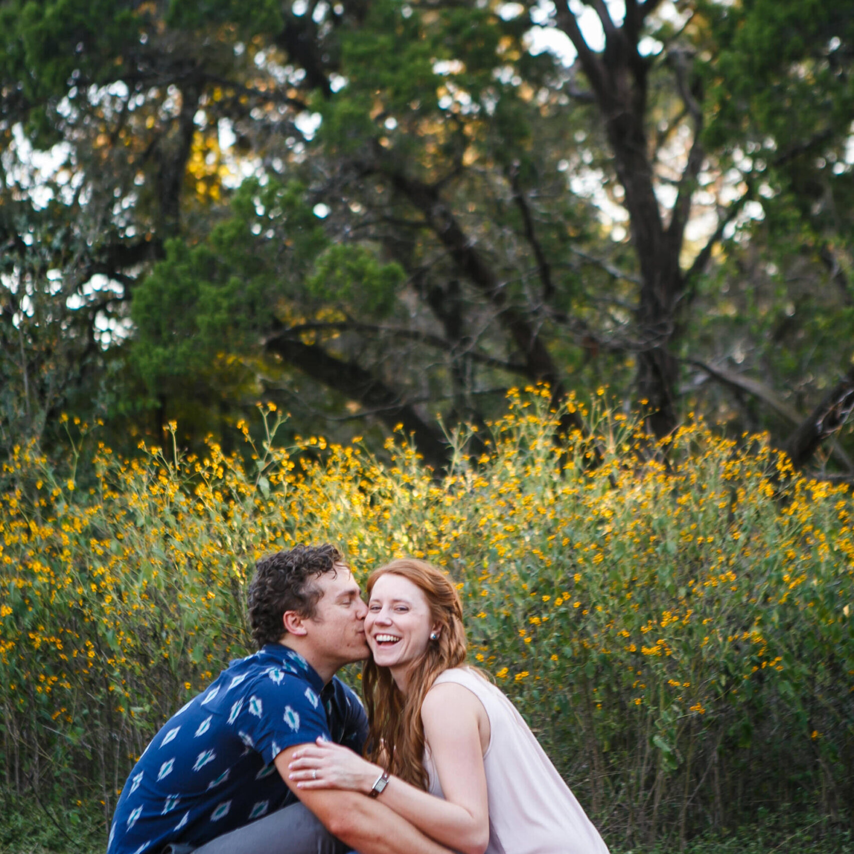 Texas Engineers Kate and Kemp Lewis sitting on a blanket in front of wildflowers