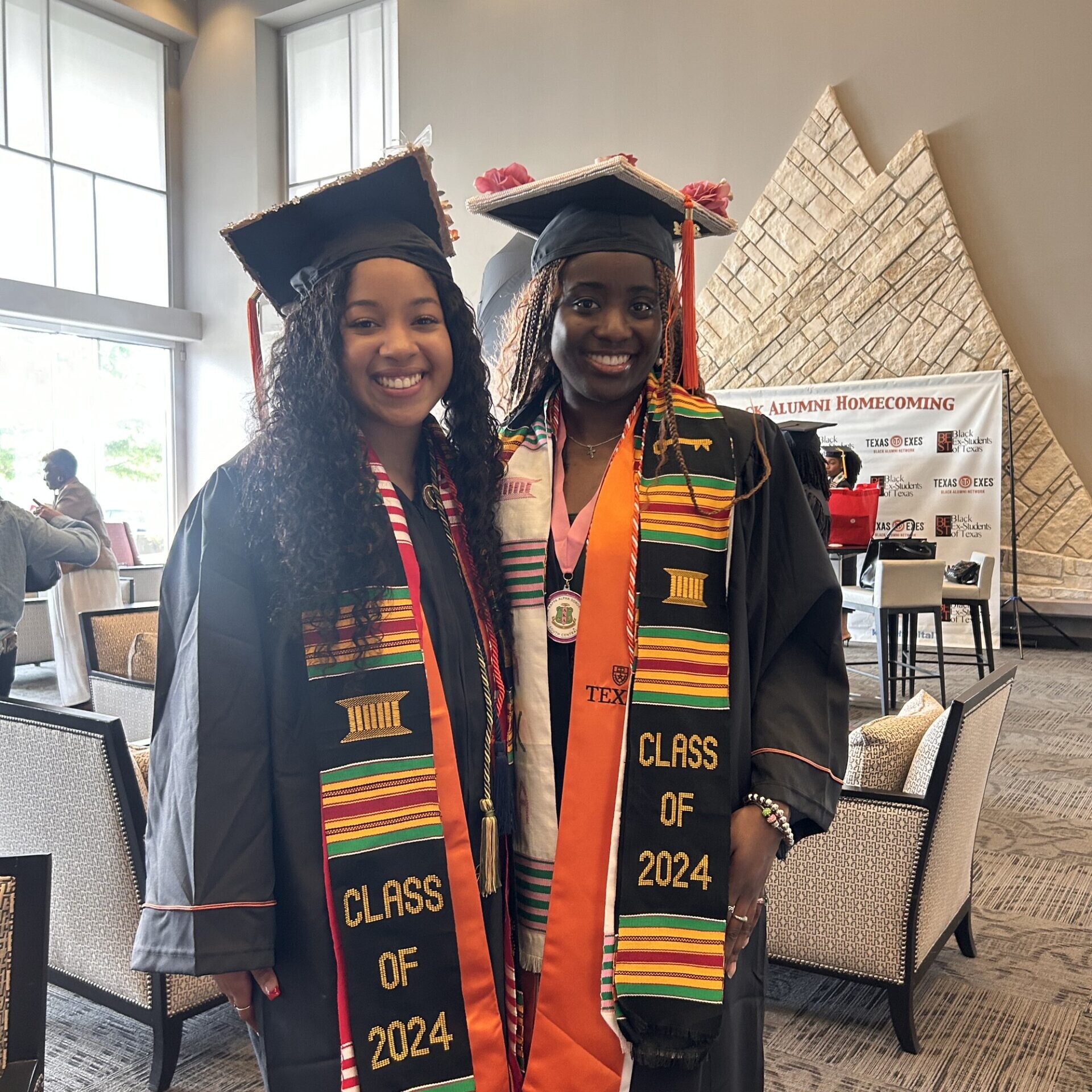NSBE Texas Engineering students smiling in graduation regalia