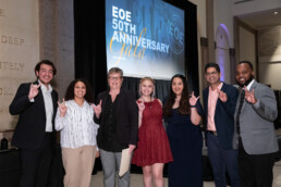 Michele Myer poses smiling with ESS staff at the EOE 50th anniversary gala.