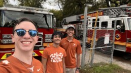 Texas Engineering students, including Siddharth Thakur, taking selfie in front of fire trucks