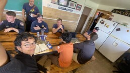 Texas Engineer Siddharth Thakur taking selfie in fire station with firefighters and other students