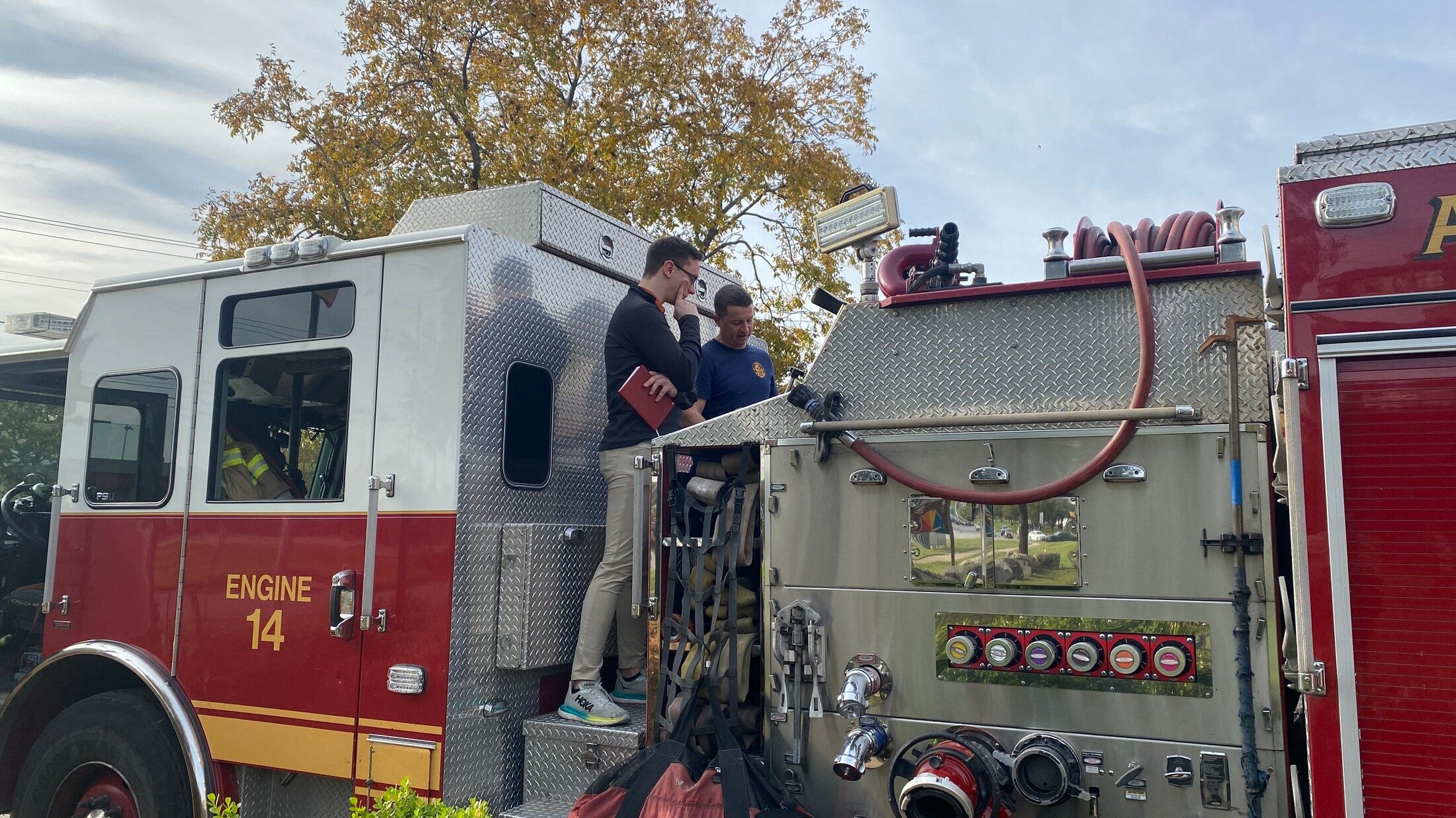 Texas Engineer and firefighter standing on fire truck