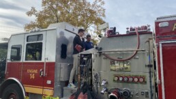 Texas Engineer and firefighter standing on fire truck