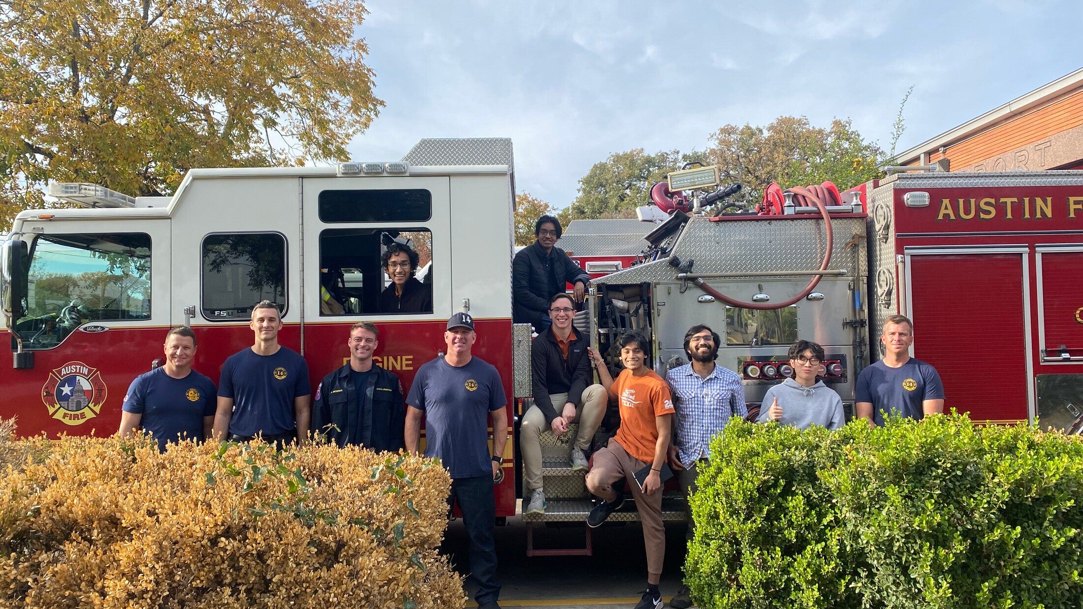Texas Engineers, including Siddharth Thakur, standing with firefighters in front of fire truck