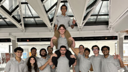 Texas Engineer Siddharth Thakur sitting on shoulders on top of team pyramid