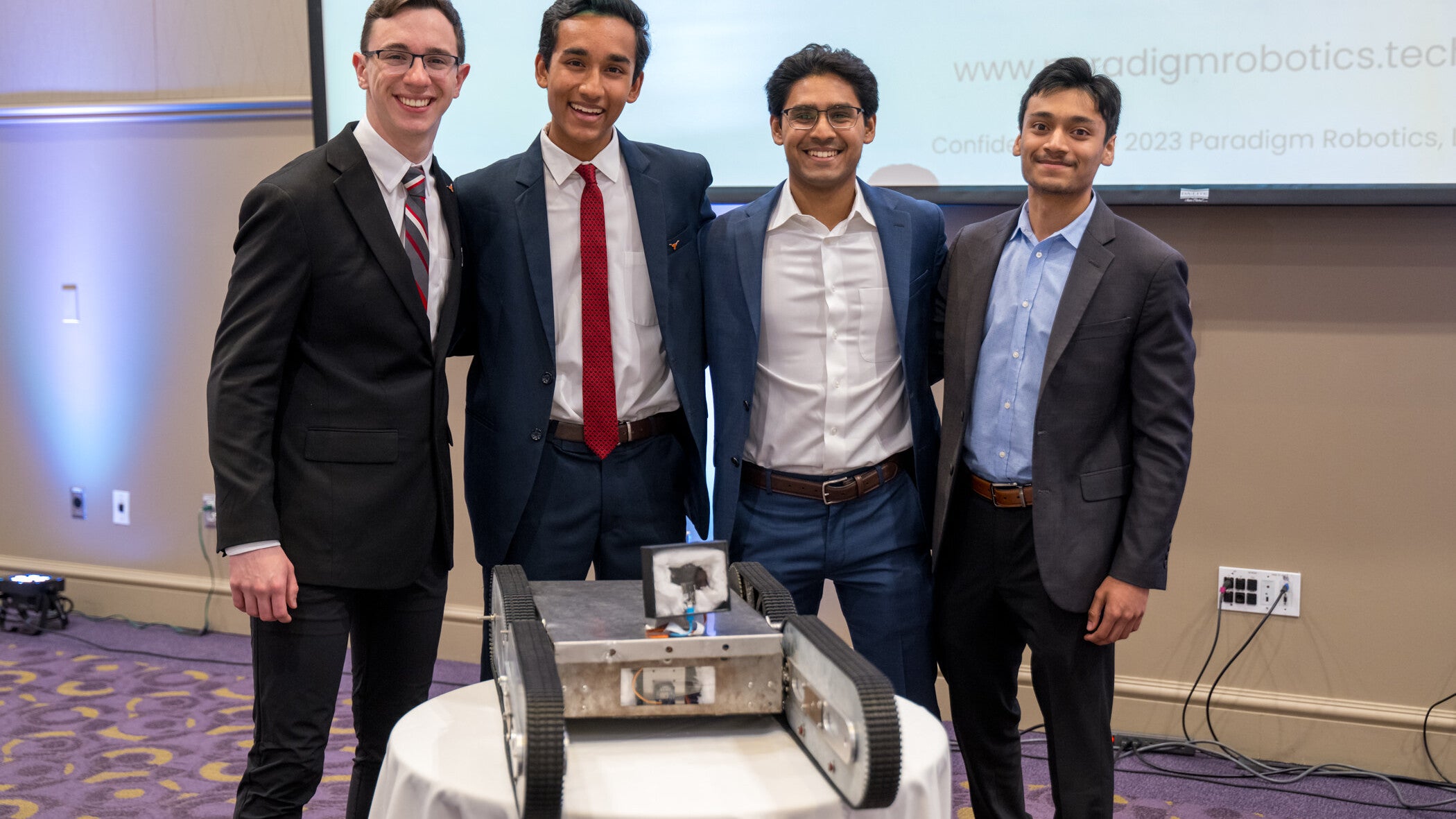 Paradigm Robotics team poses with Firebot atTech Crunch in 2023.