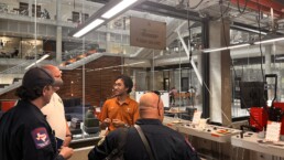 Texas Engineer Siddharth Thakur talking to firefighters in Texas Inventionworks lab space