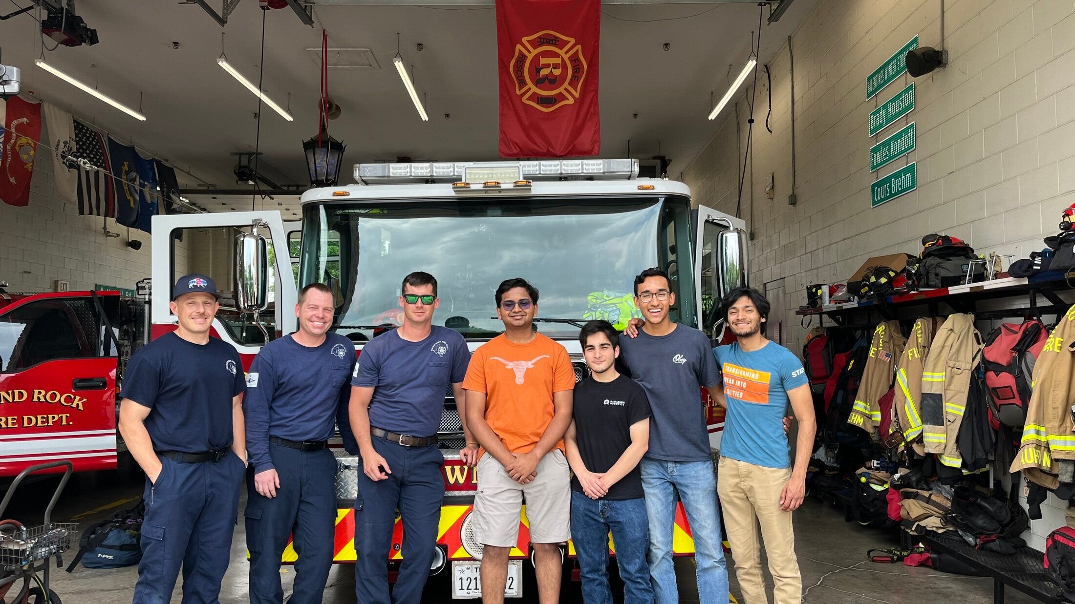 Texas Engineers, including Siddharth Thakur, standing with firefighters in front of fire truck