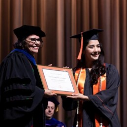 Texas Engineer Gabrielle Nomura accepting Outstanding Scholar Leader award at 2025 Commencement