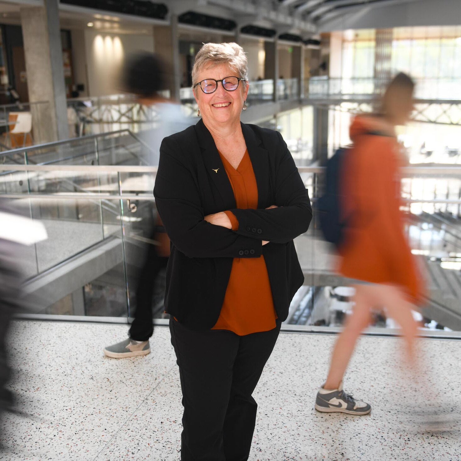 Michele Meyer stands in EER while students bustle behind her