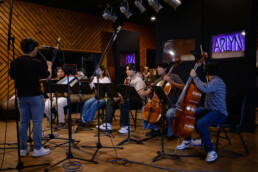 Members of ECho recording a song in Arlyn Studio on campus