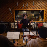 Members of ECho recording a song in Arlyn Studio on campus