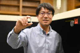 Texas Engineer Yijin Lu holding new battery prototype