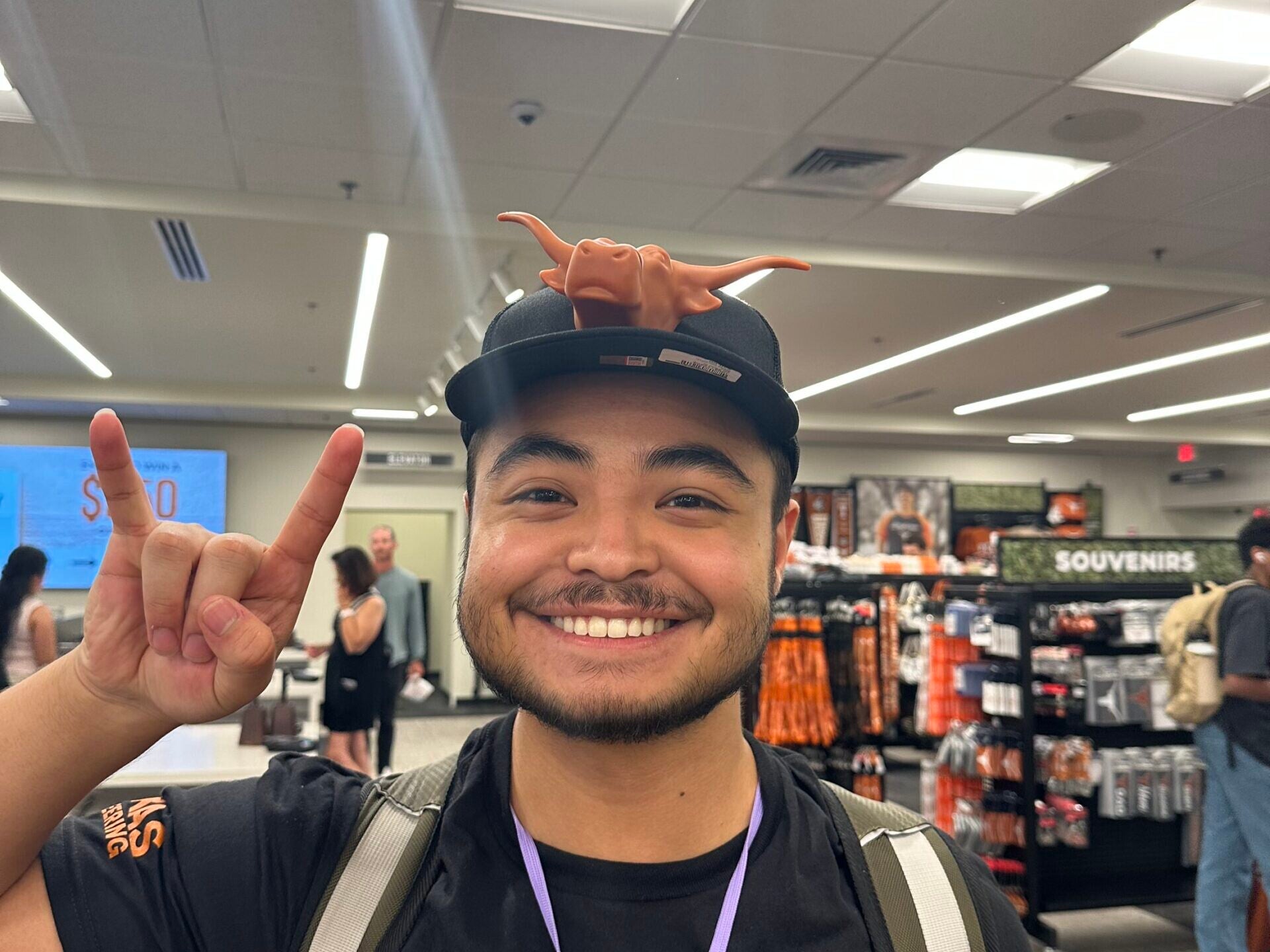 Longhorn Engineering Summer Camp counselor doing hook 'em hand sign