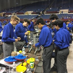 Siddharth Thakur working in middle school science competition with classmates.