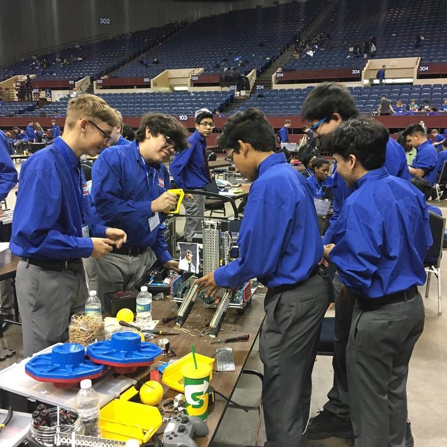 Siddharth Thakur working in middle school science competition with classmates.