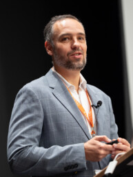 Marco Bravo at podium speaking at UT-Portugal event.