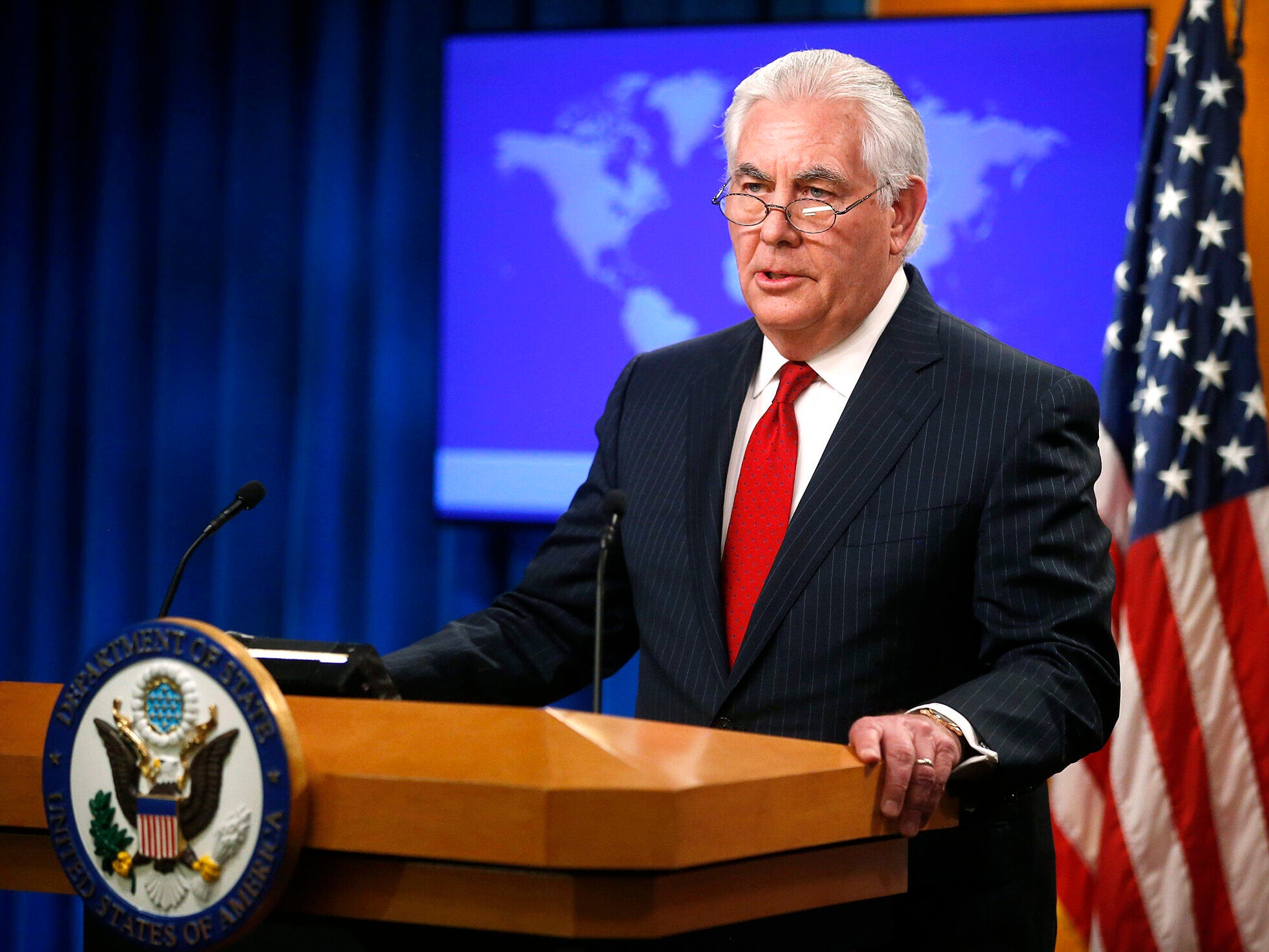 U.S. Secretary of State Rex Tillerson speaking at podium in front of American flag