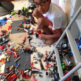 Young Siddharth Thakur at home working on legos.
