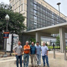 Cockrell building management all-start team stands in front of EER building.