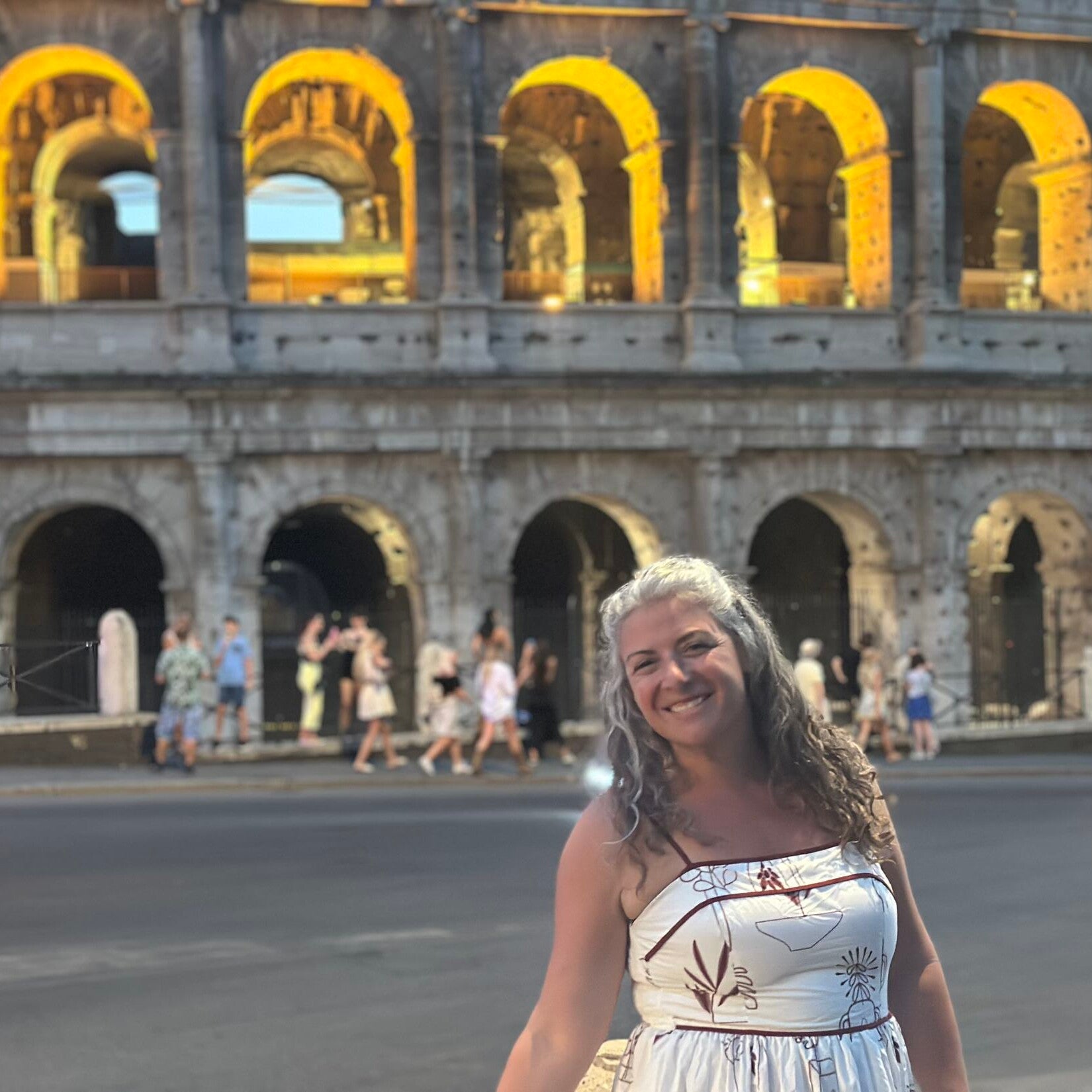Kiersten Fernandez in front of historic building in Greece.